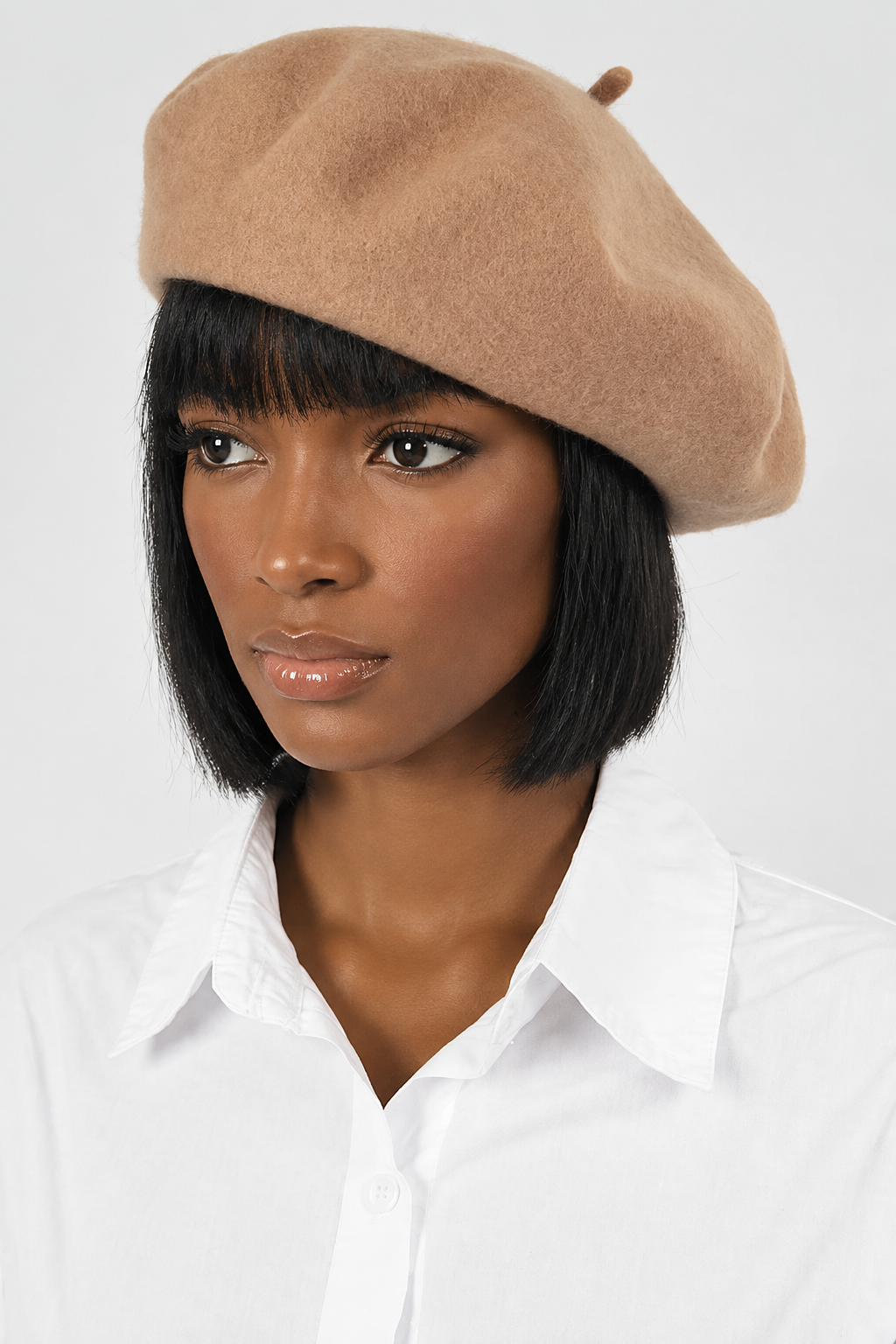 Black woman modeling the beige beret