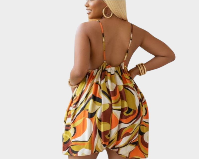 Swerves & Curves Boutique women's backless romper featuring a vibrant orange and brown abstract print pattern