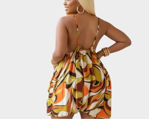 Swerves & Curves Boutique women's backless romper featuring a vibrant orange and brown abstract print pattern