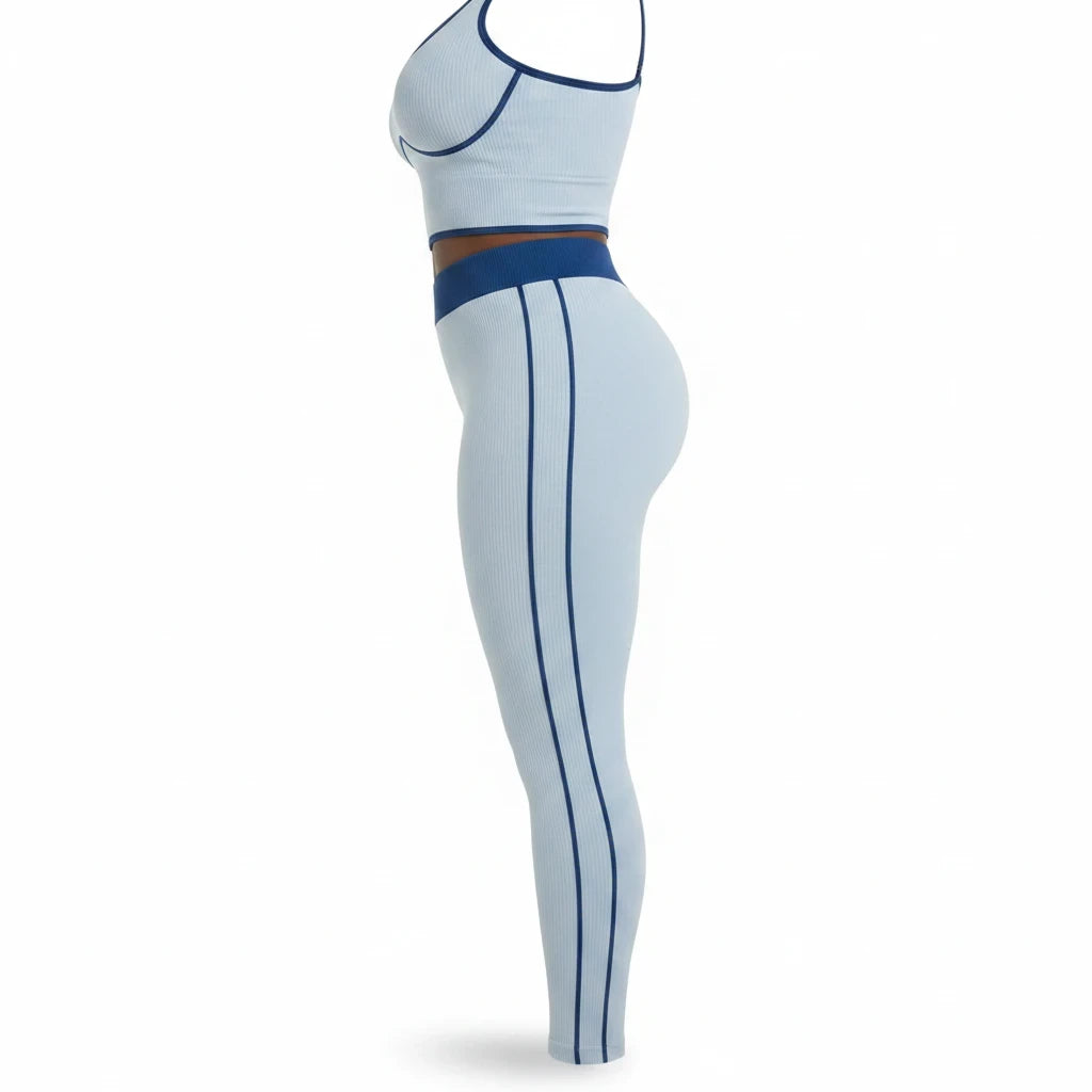 Swerves & Curves Boutique baby blue ribbed two-piece workout set with dark blue trim in a side profile view
