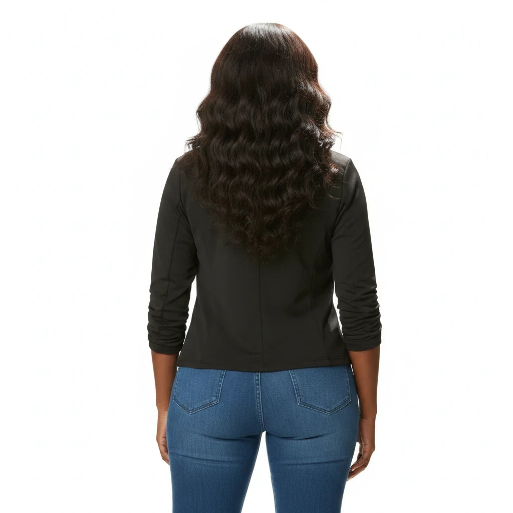 Back view of a woman wearing a black blazer and blue jeans from Swerves & Curves Boutique
