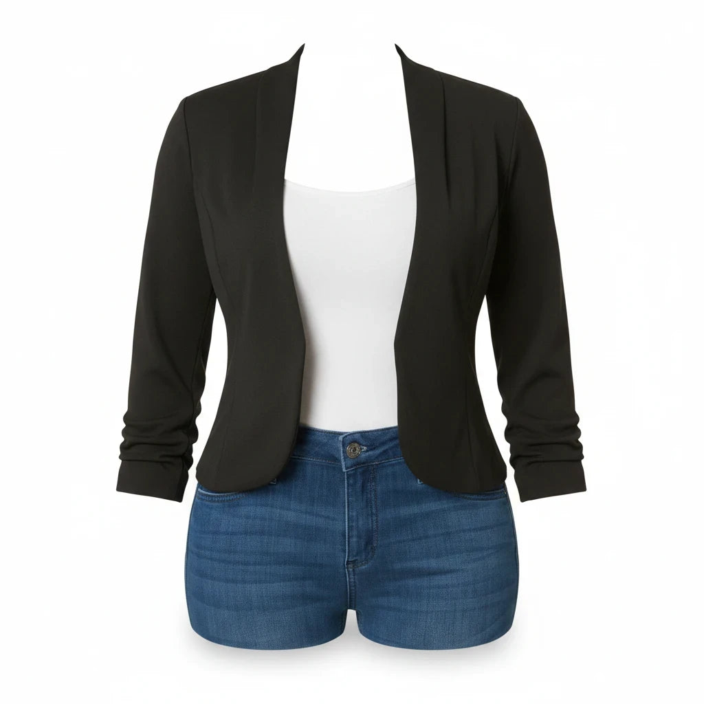 Swerves & Curves Boutique black open-front blazer layered over a white tank top and blue denim shorts