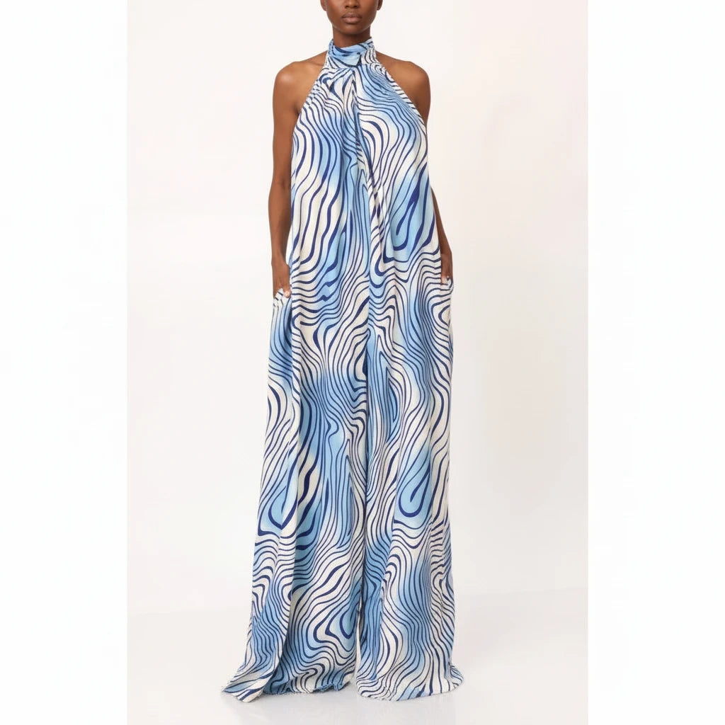 Swerves & Curves Boutique blue and white wave print halter neck backless wide-leg jumpsuit on a model