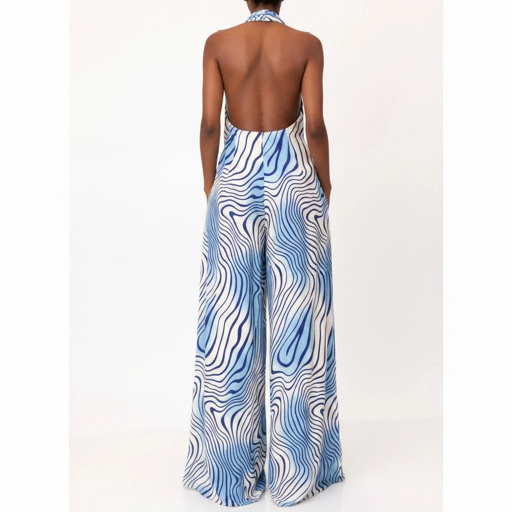 Swerves & Curves Boutique backless halter jumpsuit in blue and white wavy print with wide-leg fit, back view