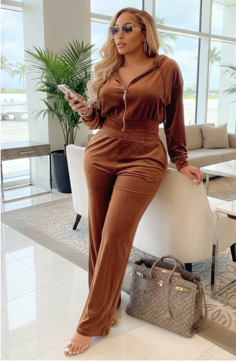 Woman wearing a brown velvet hooded zip-up jacket and matching wide-leg pants from Swerves & Curves Boutique