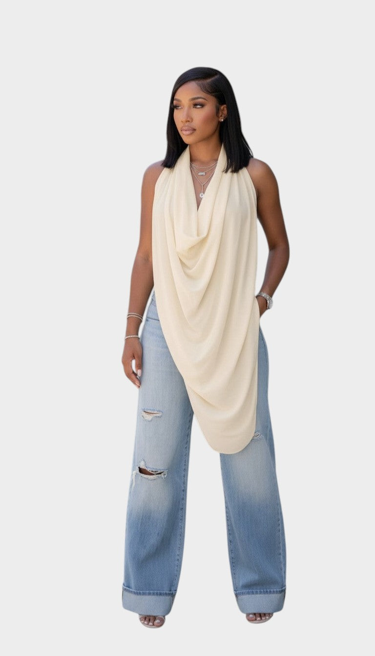 Swerves & Curves Boutique cream sheer cowl neck halter top worn by a model with light wash distressed wide leg jeans