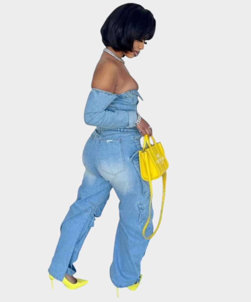 Swerves & Curves Boutique denim two-piece set with off-the-shoulder top and wide-leg pants on a model with yellow bag