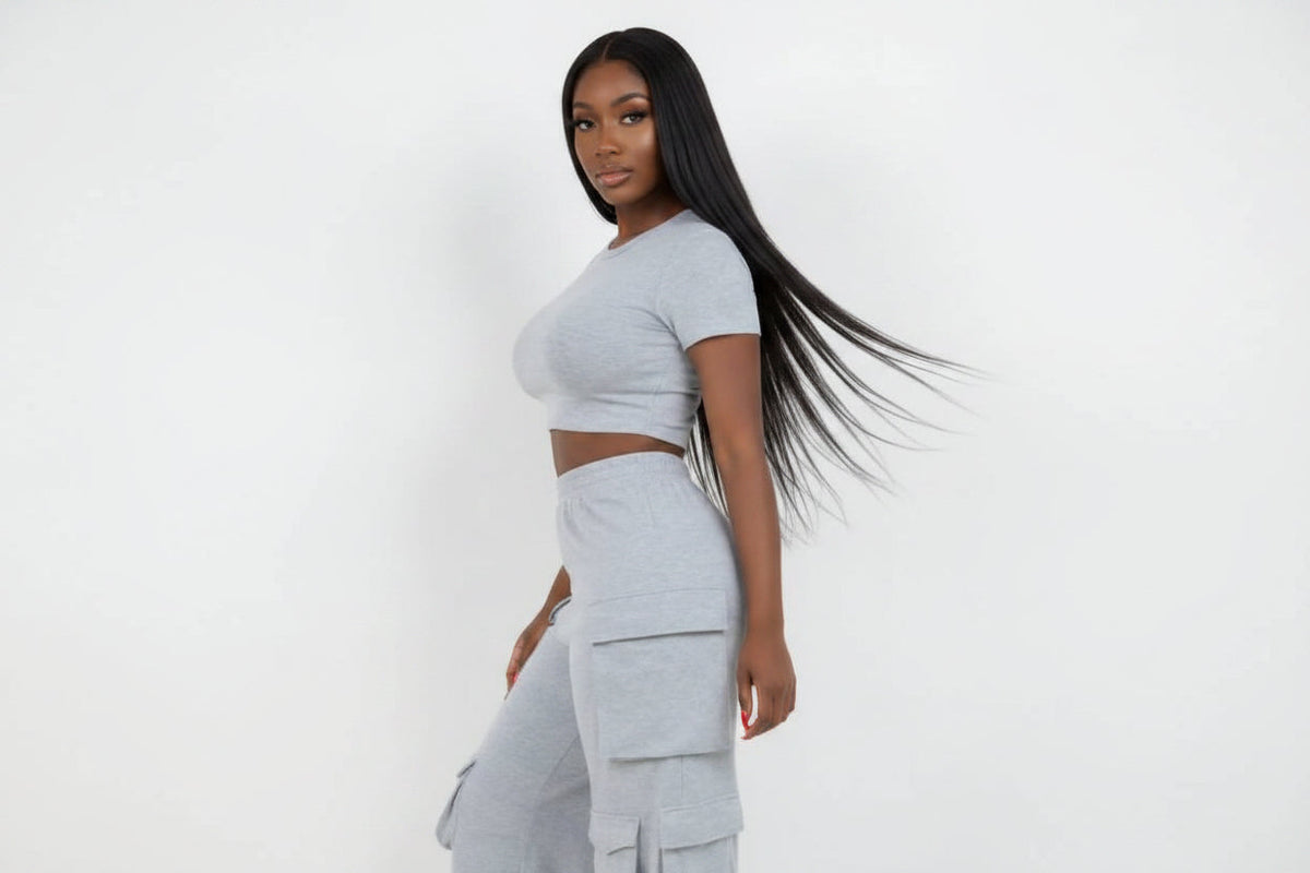 Model wearing a grey Swerves & Curves Boutique Smoke Show cargo set with a cropped top and utility cargo pants.