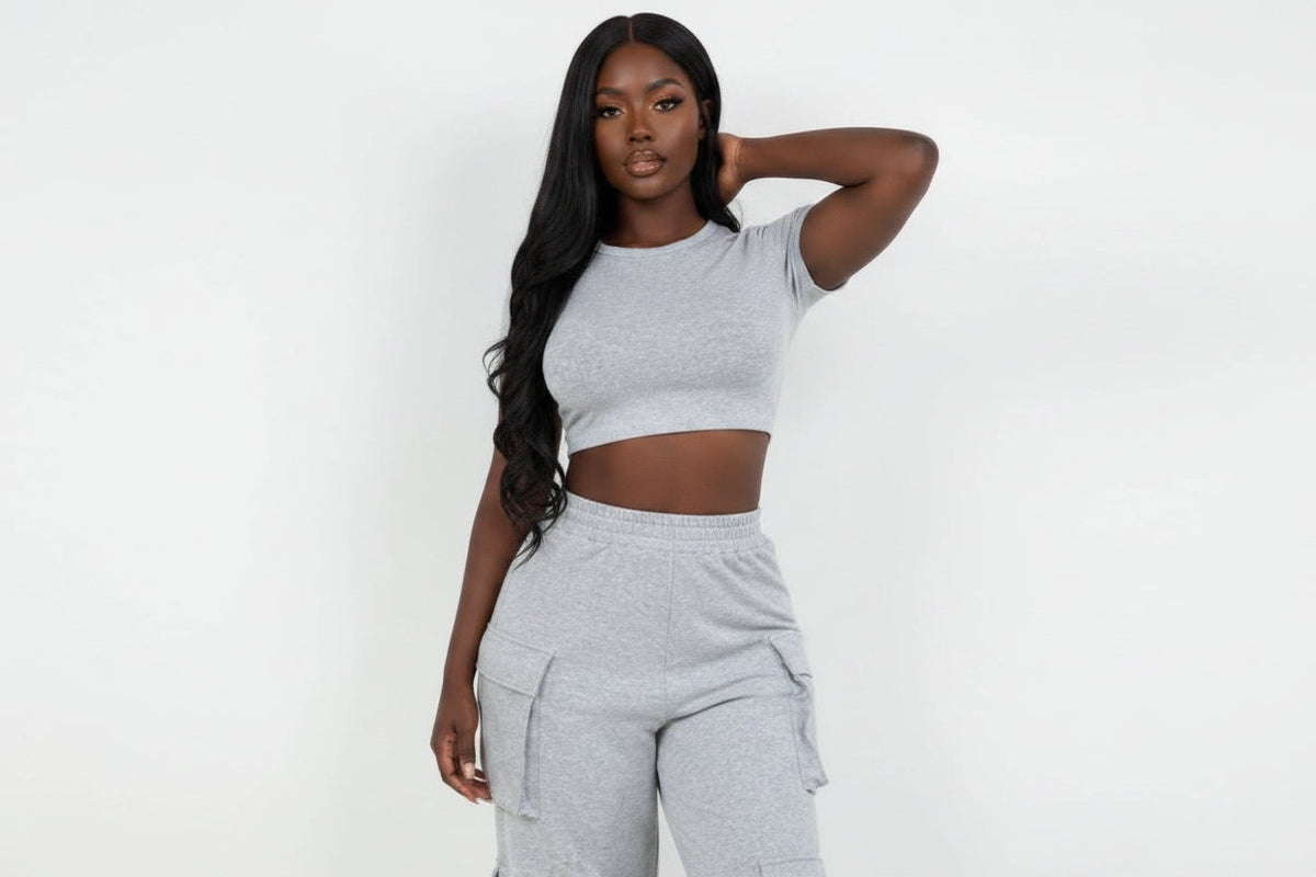 Model wearing a Swerves & Curves Boutique grey crop top and matching cargo pants set with side pockets