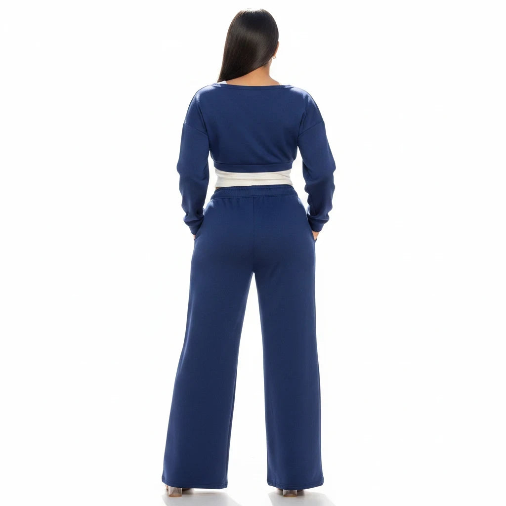 Swerves & Curves Boutique navy blue two-piece lounge set with a cropped sweatshirt and wide-leg pants, back view.