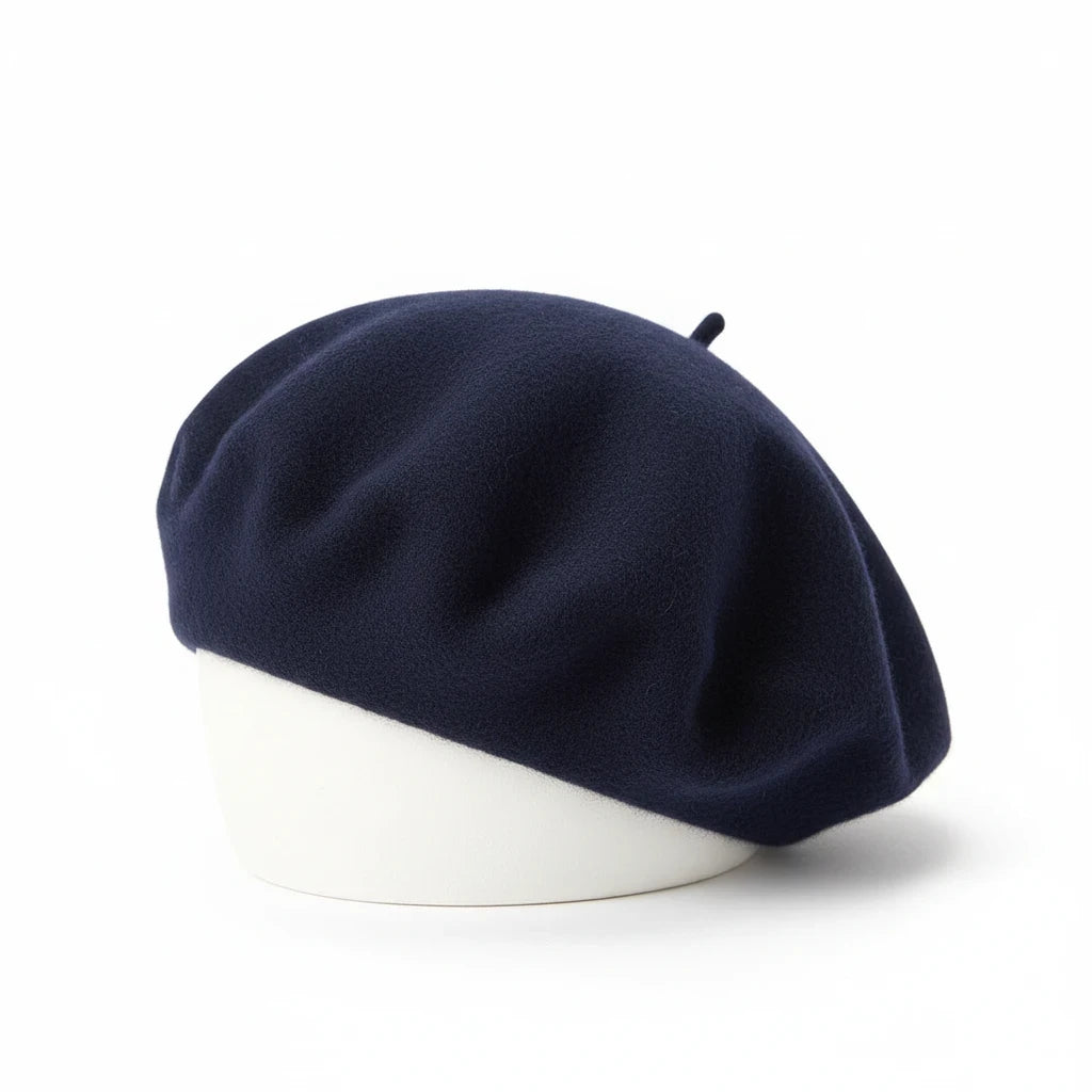 Swerves & Curves Boutique navy blue wool-blend beret with a classic rounded silhouette on a white display stand