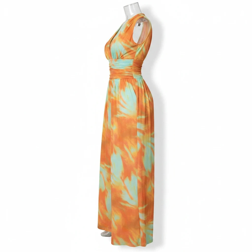 Swerves & Curves Boutique Sunset Escape jumpsuit in orange and mint watercolor print with a wide-leg silhouette.