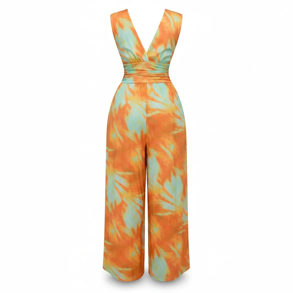 Swerves & Curves Boutique Sunset Escape wide-leg jumpsuit in orange and mint watercolor print with a deep V-neckline.
