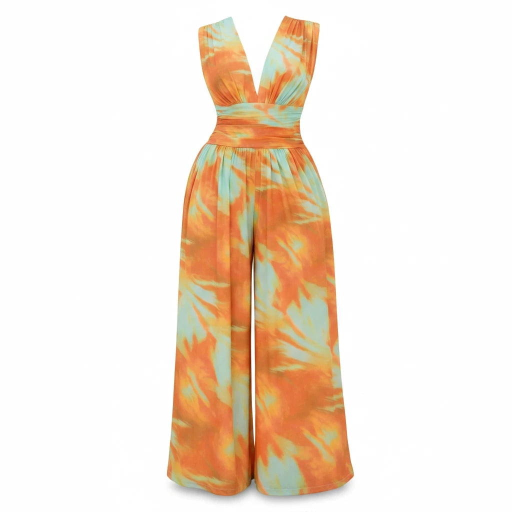 Swerves & Curves Boutique Sunset Escape wide-leg jumpsuit in an orange and mint watercolor print with a V-neckline.